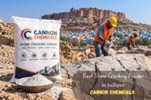 Best Stone Cracking Powder in Jodhpur Cannon Chemicals - Cannon Chemicals - Cannon Chemicals Construction site in Jodhpur with workers in orange vests pouring stone-cracking powder from a bucket beside a large Cannon Chemicals bag; Mehrangarh Fort on a hill in the background.